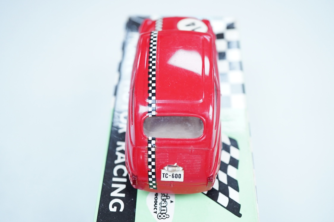 A boxed Tri-ang Scalextric T. C. Seat 600 (C-31) in red, with correct red spot box, together with an unboxed Hurricane combination motorcycle and sidecar MM/82